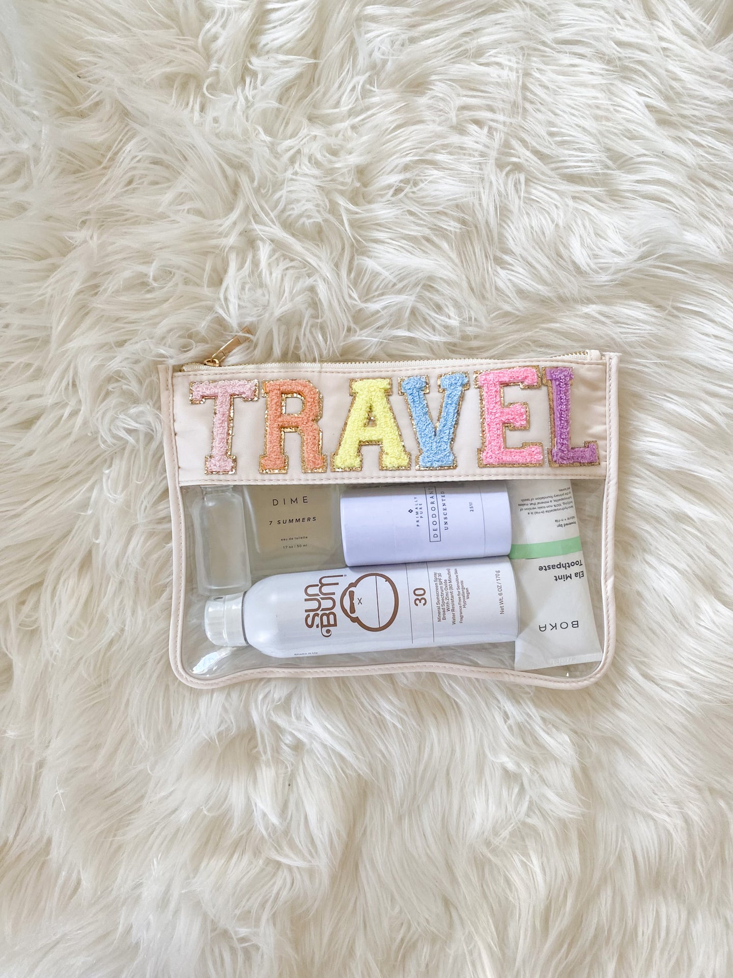 clear travel bag with rainbow chenille patches
